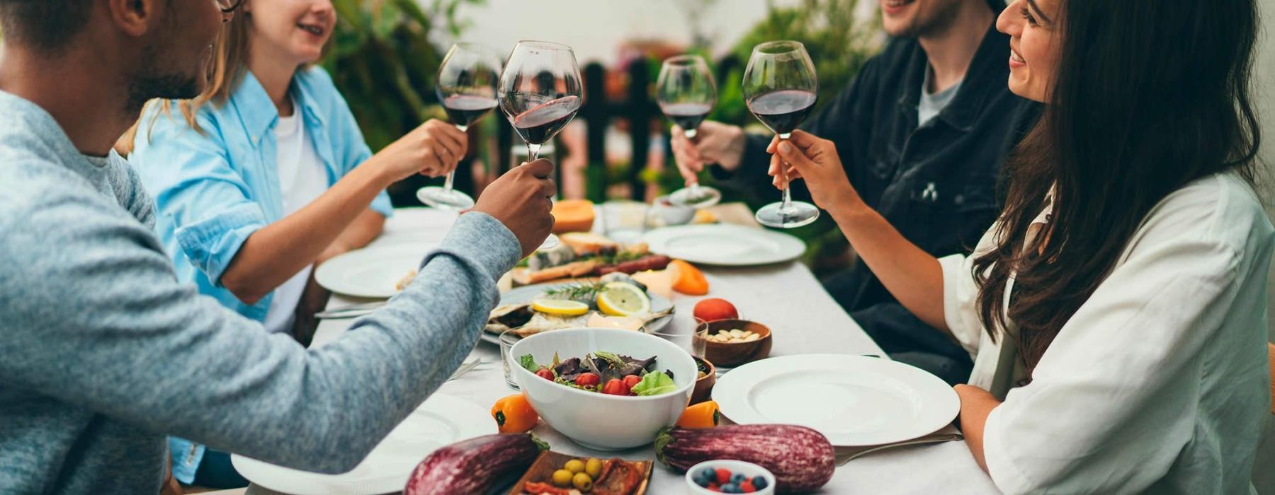 a group of people having a meal around an outdoor table